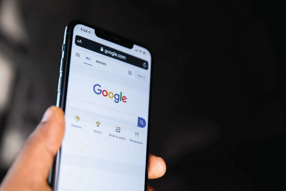 Handphone showing Google Search Homepage