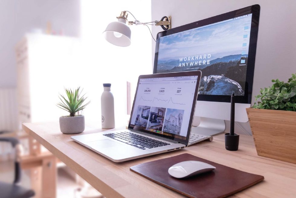 a laptop behind a desktop