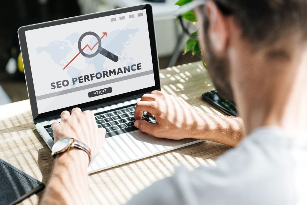back view of developer using laptop with seo performance
