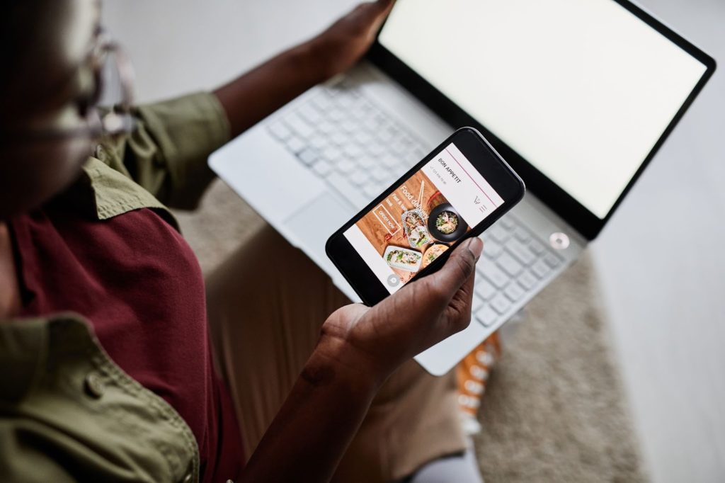 Person looking at mobile responsive interface on her phone